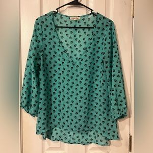 Sheer teal with black skulls top